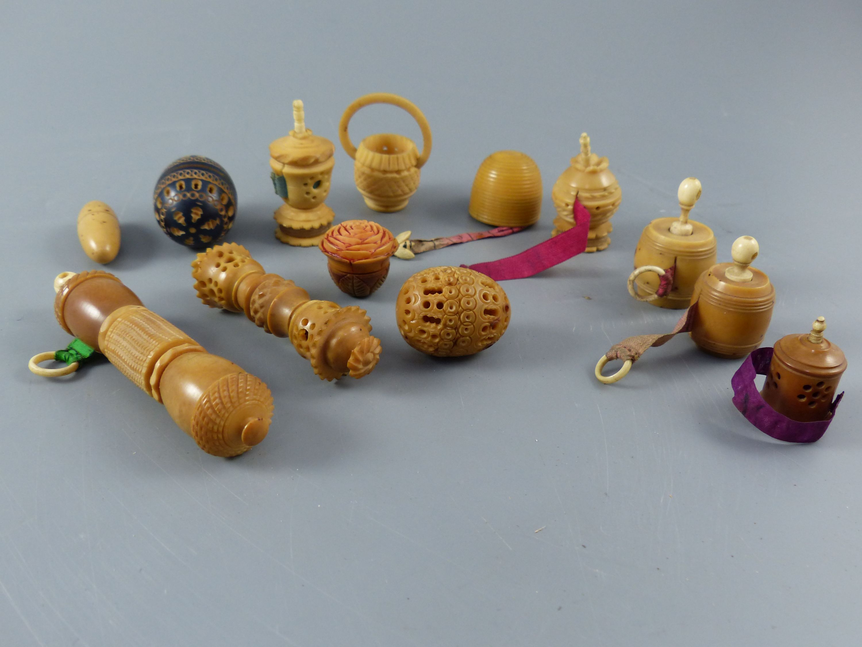 A collection of assorted 19th century carved and turned coquilla nut sewing accessories